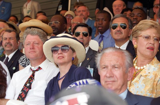 President Bill Clinton (left, white shirt) and First Lady Hillary Clinton (in blue, wearing sunglasses) watching the opening match in Chicago.