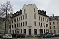 Apartment building in a semi-open area in a corner with a shop and front garden