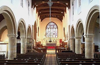 The nave of Bourne Abbey today. The two nave arcades are consistent with a building date of around 1138 as are the responds from the chancel screen, visible at the entrance to the chancel. The repaired scars from the removal of the pulpitum can be seen below them. In the building there are stones carved into the form of arches of a style consistent with the later 12th century. These are likely to be from the eastern side of this pulpitum screen, which would have obscured the view of the chancel while allowing sounds out from it. BourneAbbeyInterior.jpg