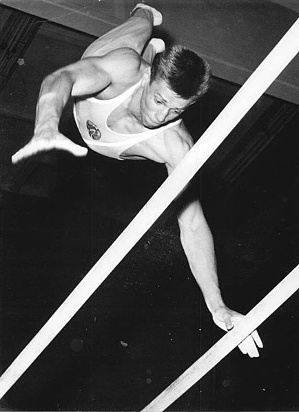 A gymnast performing on the parallel bars in 1962.