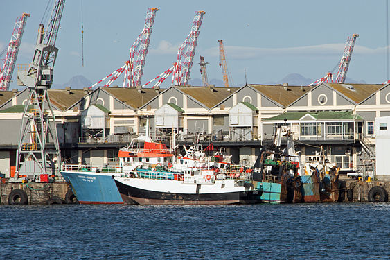 Big and small fishing vessels – a longliner moored alongside a larger trawler