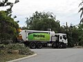 Recycling truck emptying a roadside bin in the City of Stirling LGA, Perth, Western Australia. Isuzu truck with a MacDonald Johnston side loader body.