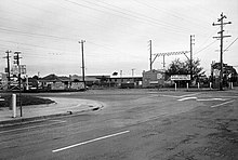 A black and white photo of the level crossing at Clayton Road, Clayton with manually operated gates before its removal.