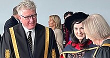 This is a shot of Moya Doherty after receipt of an honorary doctorate from DCU, with the university's president and its chancellor to either side, as taken in May 2022