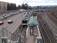 MAX light rail along the Banfield Freeway (I-84) Eastbound train at Northeast 60th Avenue station, February 2018.jpg