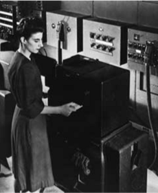 Frances Bilas Spence feeding punch cards into ENIAC, Feb 1946.png