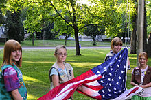 Girl scouts raising US flag.jpg