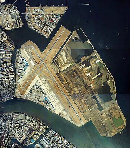 An aerial view of Haneda in 1984 showing the 1970 terminal on the west side of the field, the site of which is now occupied by Terminal 3. The large area under reclamation to the east would become the site of today's Terminal 1 and Terminal 2.