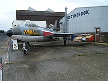 A Hawker Hunter fighter jet in the markings of No. 63 Sqn