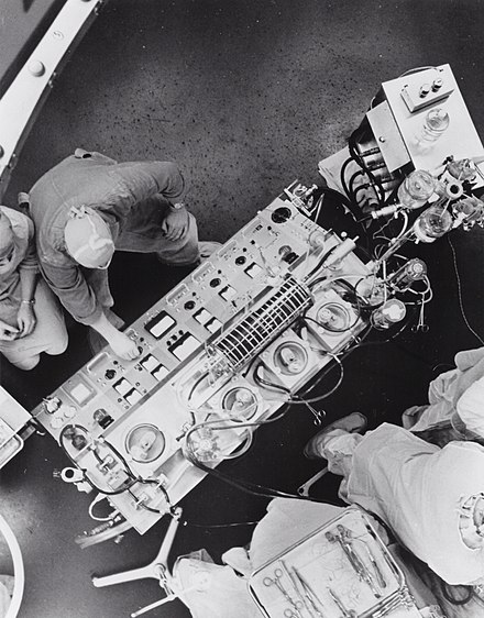 An operating room in the United States, c. 1960. Heart-Lung Machine with rotating disc oxygenator