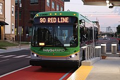 An IndyGo battery electric bus approaching a Red Line station IndyGo Red Line opening 05.jpg