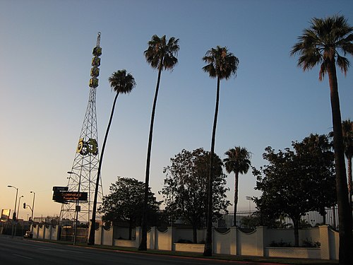 KTLA tower on Sunset Boulevard in 2007. The tower was erected in 1925, and was one of two radio towers that served Warner Bros.-owned radio station, KFWB, from the Warner Brothers Studio (now Sunset Bronson Studios) in Hollywood; the second tower was permanently removed in 1950. KTLA moved to the property in 1955, and added its call letters to the structure, which was moved to another spot on the property; the tower was relocated back to its original site in 2015. The station does not actually broadcast from this tower, with its main transmitter being positioned atop Mount Wilson.