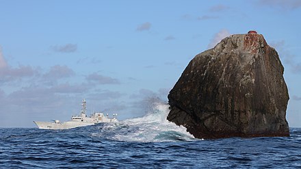 Rockall — access by boat only, if you can manage to land on it. Here, an Irish coast guard boat provides a perspective for the size of the rock and the swell breaking at it.