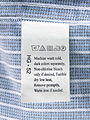 Laundry symbols on a care label attached to a shirt.JPG