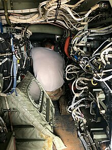 Repairing avionics equipment in a C-130J.