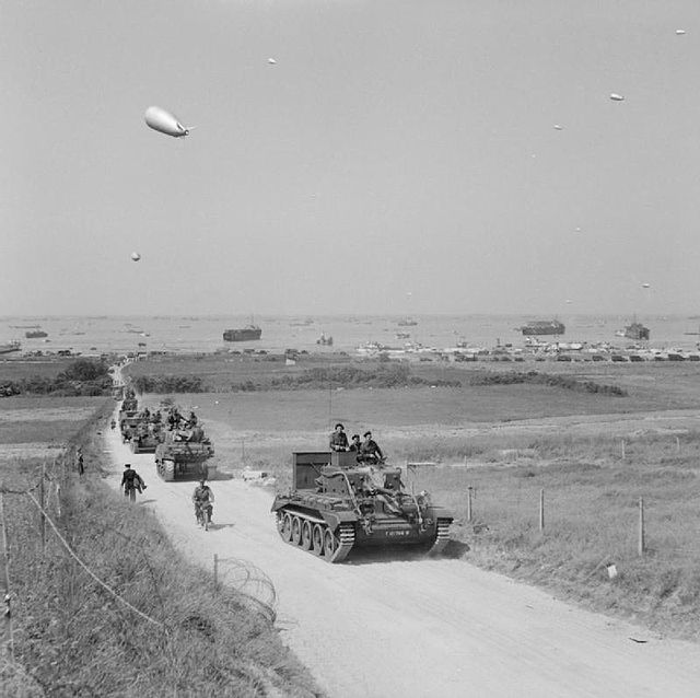 Tanks from the 4th County of London Yeomanry, 7th Armoured Division, move inland from Gold Beach, 7 June 1944.