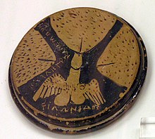 Attic red-figure lid depicting three vulvae and a winged phallus. Origin unknown, c. 460-425 BC. Housed in the National Archaeological Museum in Athens. NAMA Phallus aile.jpg