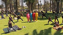 The members of OK Go (in the bright color sweatsuits) among several extras in the "End Love" music video. OK Go - End Love.jpg