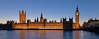 Modern view of the Houses of Parliament at dusk in an approximately identical angle. The paintings were framed to exclusively depict the leftmost half of the building, with Victoria Tower as the focal point.