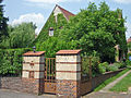 Villa with enclosure, gate, arch, garage and parts of the garden design