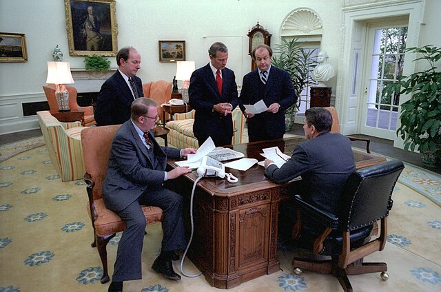 President Reagan holds an oval office staff meeting on his first full day in office. Front left, Counselor to the President Edwin Meese.