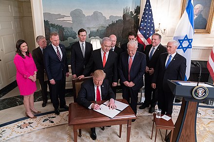 President Trump, joined by Netanyahu behind, signs the proclamation recognizing Israel's 1981 annexation of the Golan Heights, March 2019