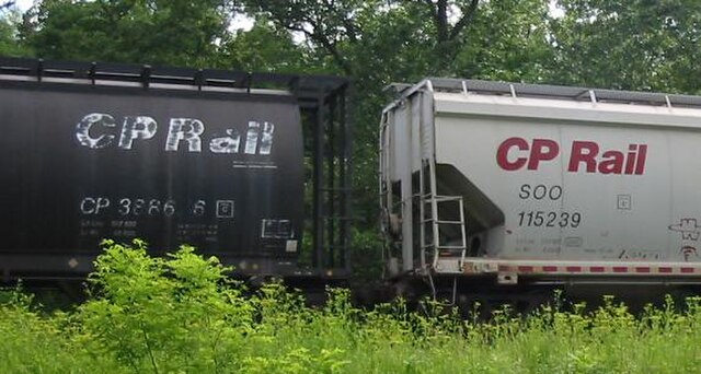 Reporting marks on two Canadian Pacific covered hopper cars; with the left car marked as CP 388686 and the right car marked as SOO 115239
