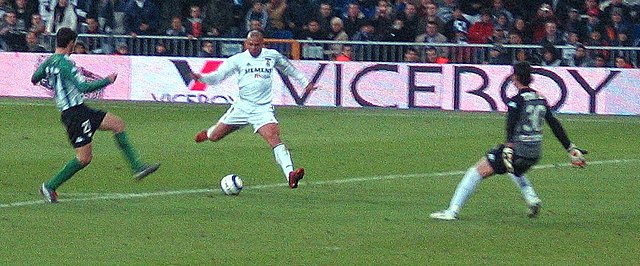 Brazilian striker Ronaldo (middle, in white) taking a shot at goal. A multi-functional forward, he has influenced a generation of strikers who followe