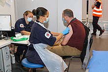 Royal Navy personnel administering COVID-19 vaccinations in Bristol during early 2021 Royal Navy COVID vaccine administration.jpg