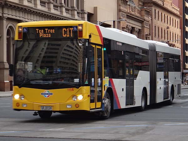 Scania K320UA articulated bus in the CBD, with right-hand guide wheel visible