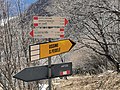 Guidepost at the junction with the ex military road to Monte di Tremezzo, directions towards San Fedele