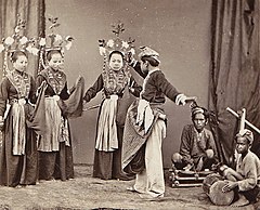 Tandako pajogé dancers and musicians in Gorontalo, North Celebes, circa 1870s.