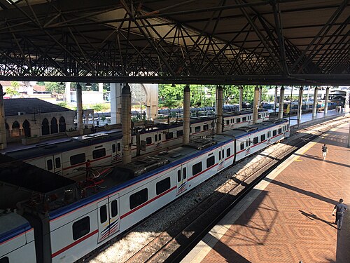 KTM Komuter Class 92 and Class 83 trains waiting at the newer wing of Kuala Lumpur station, built during the 1986 refurbishment.