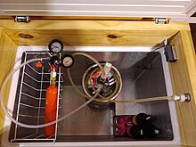 Inside of a keezer with shank/tap, temperature control and the door hinges attached to the wood collar. Tubo Drago para cerveza.jpg