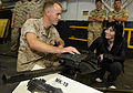 US Navy 090518-N-3595W-321 Lance Cpl. Sean Godfrey, assigned to the 26th Weapons Company, based at Camp Lejeune, N.C., gives Joan Jett, lead singer of Joan Jett and the Blackhearts, an overview of the MK-19 40mm machine gun.jpg