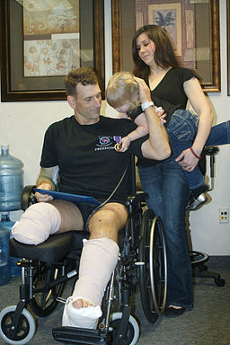 US Navy 110419-N-KE905-026 Explosive Ordnance Disposal Technician 1st Class Todd E. Hammond shows his Purple Heart medal to his two-year-old daught