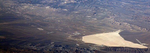 Yucca Flat has hundreds of subsidence craters from underground nuclear weapons tests. Asian Lake is visible on the right.