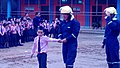 A CHILD WITH FIREMAN TO EDUCATE THE MEASURE TO SAVE FROM FIRE ACCIDENT.jpg