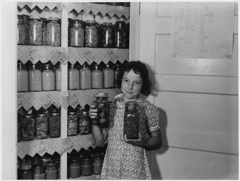 File:A girl holding two jars of canned goods - NARA - 196256.tif