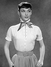 Hepburn film test photo dressed in skirt with white blouse.