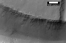 Close up view of previous image, as seen by HiRISE. Small round dots are boulders.