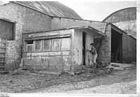 A section of a carriage which had been used as beach hut at Westward Ho!, close to the Nassau Baths being inspected by Roger Griffith from Grenville College in the 1960s BWHARhalfcarriage.jpg