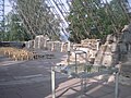 Table and chairs, photo from the back showing chairs and glass roof in the at the