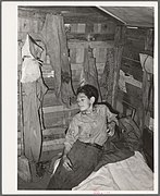 Boy in corner of shack home near Mays Avenue. Oklahoma City, Oklahoma.jpg