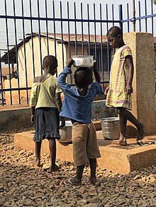 Children fetching water. Brother and sister fetching water - Asutifi North.jpg