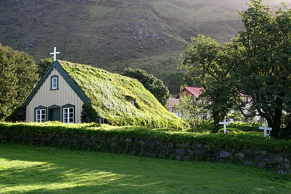 A small wood and turf church in Hof, Iceland.