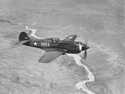 A three-quarter view of a P-40B, X-804 (s/n 39-184) in flight. This aircraft served with an advanced training unit at Luke Field, Arizona.