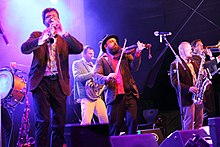 a photograph of members of Dobranotch performing on stage in 2016