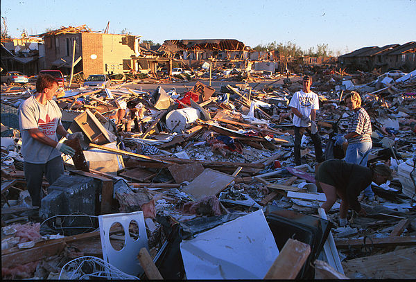 Residents search for belongings in the remains of their homes.