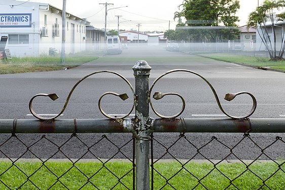 Fence detail with passing car